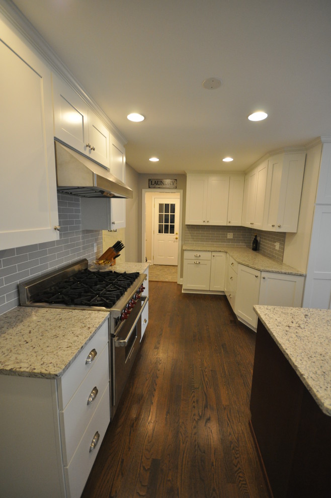 Eat-in kitchen - large transitional u-shaped dark wood floor and brown floor eat-in kitchen idea in DC Metro with an undermount sink, shaker cabinets, white cabinets, green backsplash, subway tile backsplash, stainless steel appliances and an island