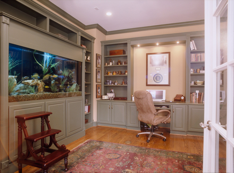 Photo of a mid-sized arts and crafts study room in Houston with beige walls, light hardwood floors and a built-in desk.