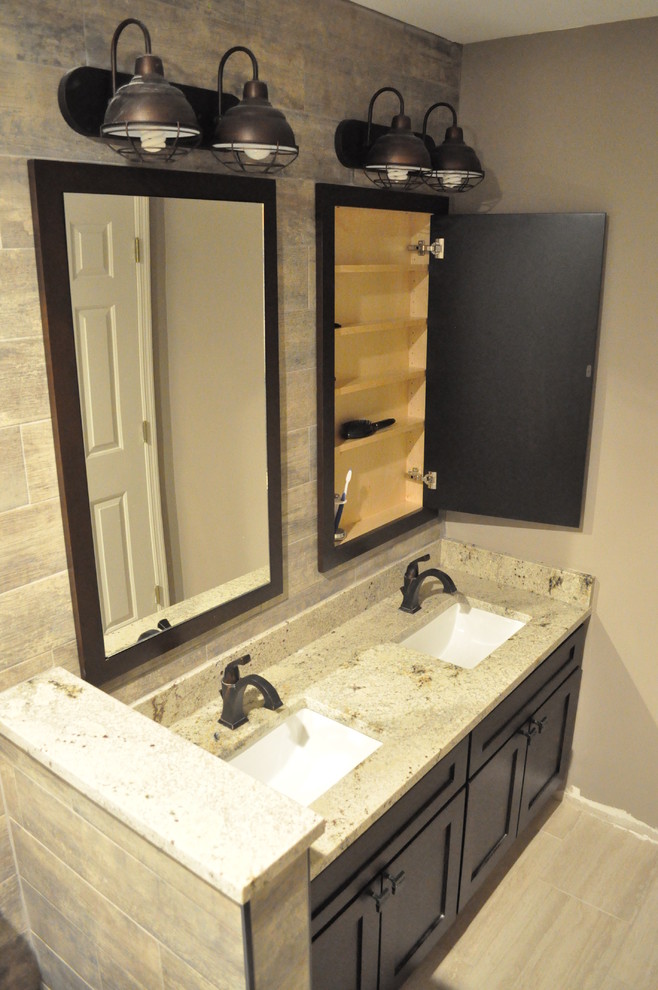 Design ideas for a small industrial kids bathroom in Atlanta with an undermount sink, shaker cabinets, dark wood cabinets, granite benchtops, a shower/bathtub combo, a two-piece toilet, brown tile, ceramic tile and ceramic floors.