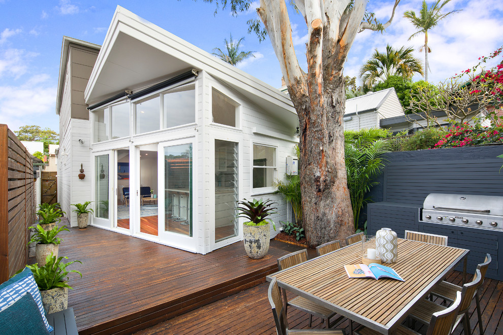 Contemporary backyard deck in Sydney with no cover.