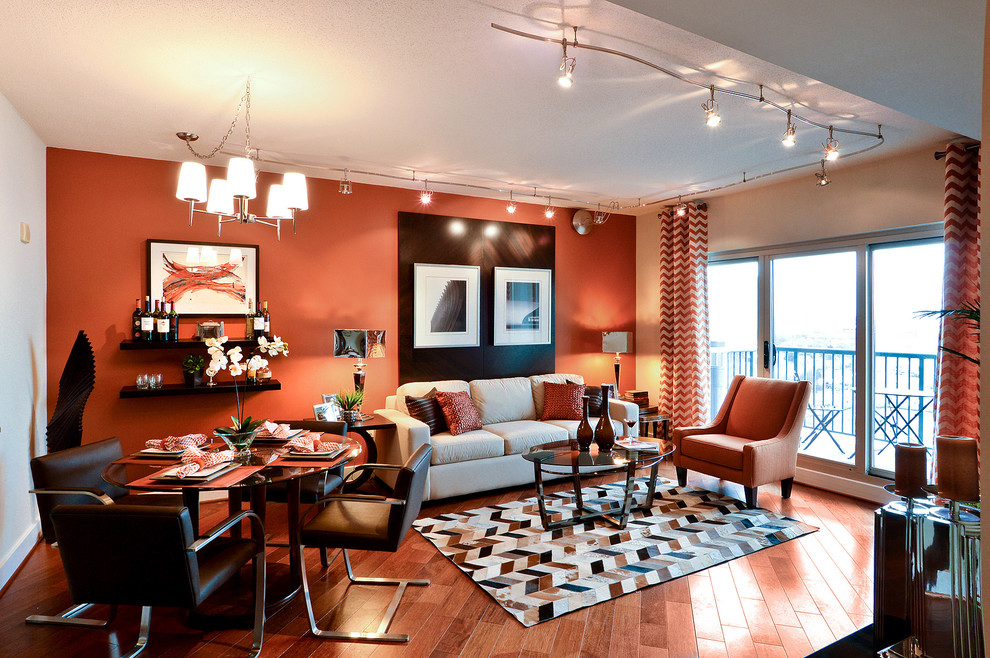 Living room - small contemporary open concept medium tone wood floor living room idea in Philadelphia with orange walls and a wall-mounted tv
