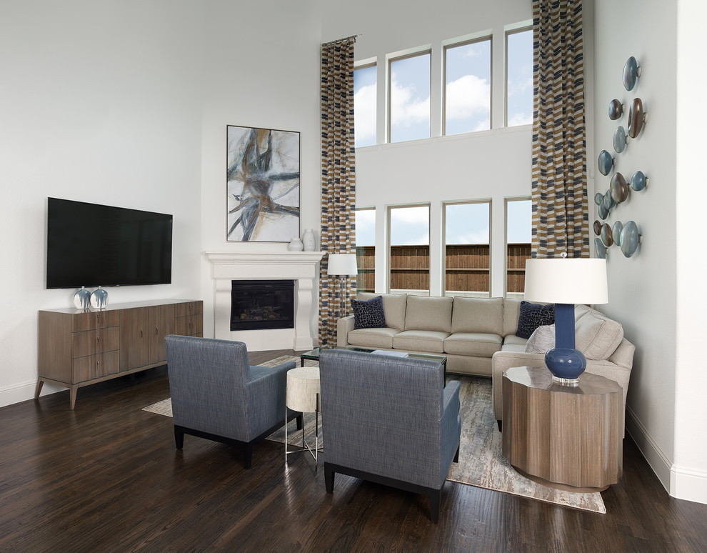 This is an example of a contemporary formal open concept living room in Dallas with white walls, dark hardwood floors, a corner fireplace, a wood fireplace surround, a wall-mounted tv, brown floor and vaulted.