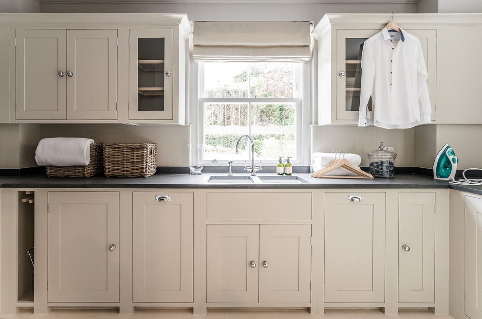 Design ideas for a large contemporary l-shaped dedicated laundry room in Gloucestershire with an undermount sink, shaker cabinets, white cabinets and granite benchtops.
