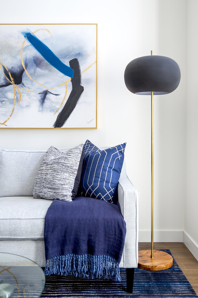 Example of a small minimalist open concept laminate floor and brown floor living room design in Calgary with white walls and a wall-mounted tv