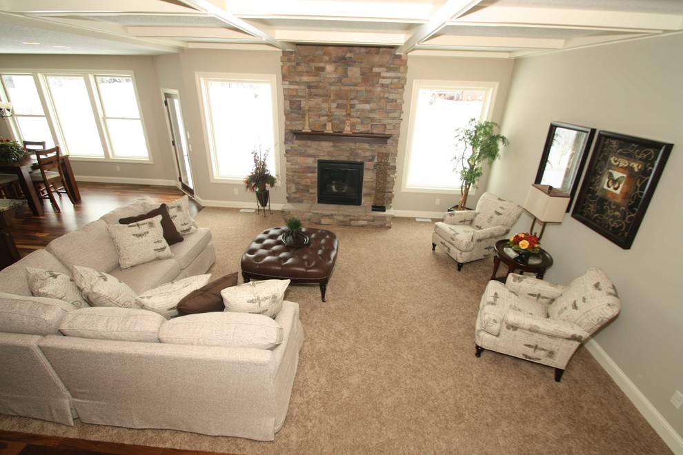 Design ideas for a traditional open concept living room in Minneapolis with grey walls, carpet, a standard fireplace, a stone fireplace surround and no tv.