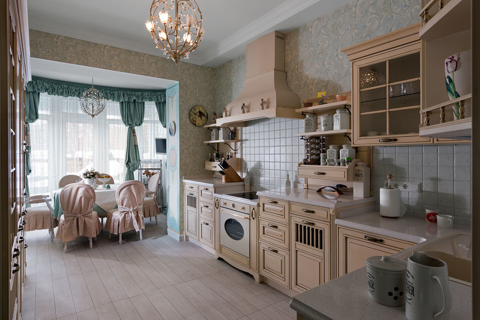 Photo of a mid-sized traditional u-shaped eat-in kitchen in Other with light wood cabinets, white splashback, ceramic splashback and ceramic floors.