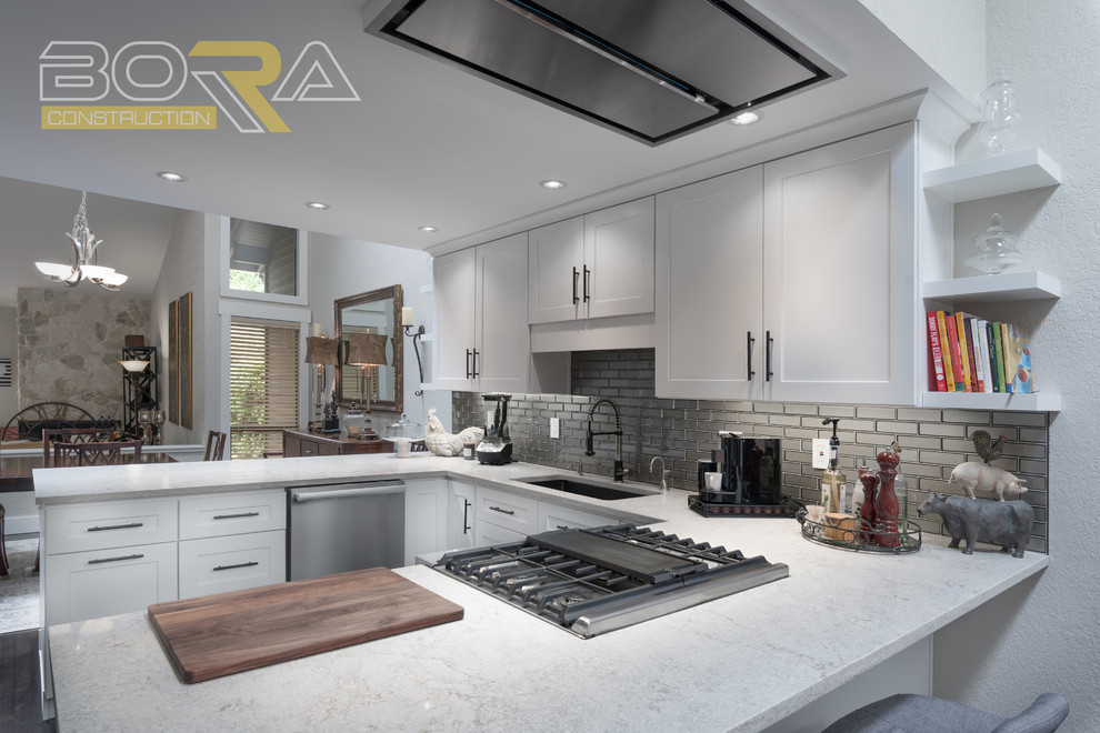Example of a mid-sized transitional u-shaped dark wood floor and brown floor eat-in kitchen design with an undermount sink, recessed-panel cabinets, white cabinets, wood countertops, metallic backsplash, ceramic backsplash, stainless steel appliances and a peninsula