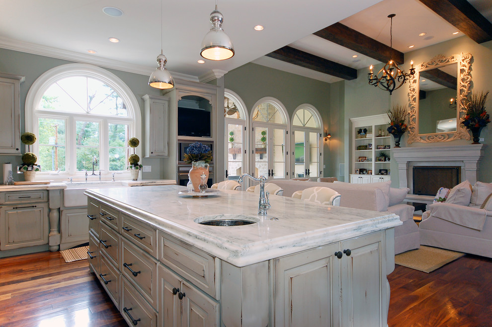 This is an example of a traditional open plan kitchen in St Louis with a farmhouse sink.