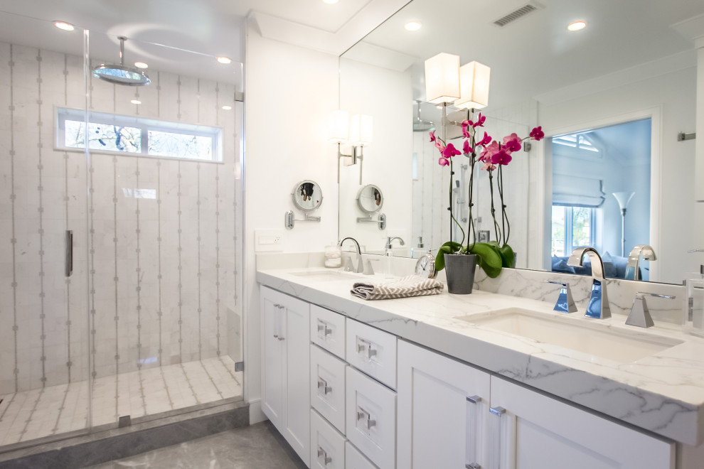 Alcove shower - transitional master gray tile and white tile gray floor and double-sink alcove shower idea in Orange County with shaker cabinets, white cabinets, white walls, an undermount sink, marble countertops, a hinged shower door, multicolored countertops and a floating vanity