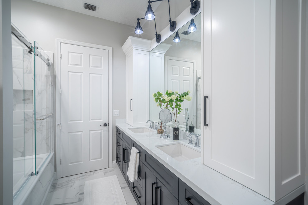 Small industrial kids bathroom in Miami with shaker cabinets, grey cabinets, an alcove tub, an alcove shower, white tile, ceramic tile, grey walls, porcelain floors, an undermount sink, quartzite benchtops, white floor, a sliding shower screen and white benchtops.