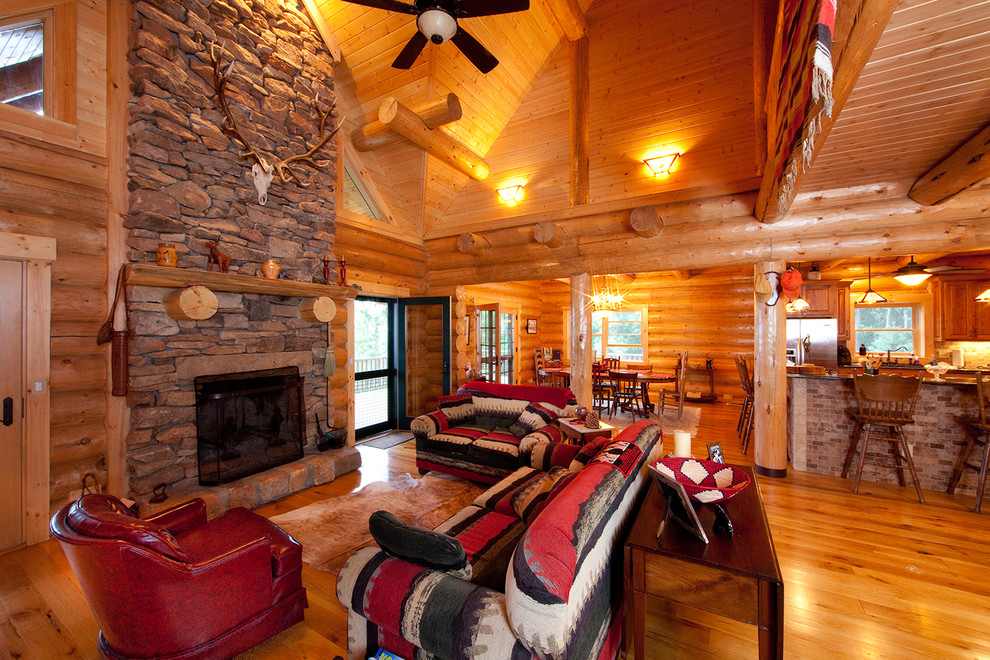 Design ideas for a small country open concept family room in Other with light hardwood floors, a standard fireplace and a stone fireplace surround.