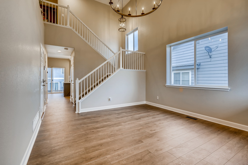 Inspiration for a large timeless vinyl floor and brown floor entryway remodel in Denver with gray walls