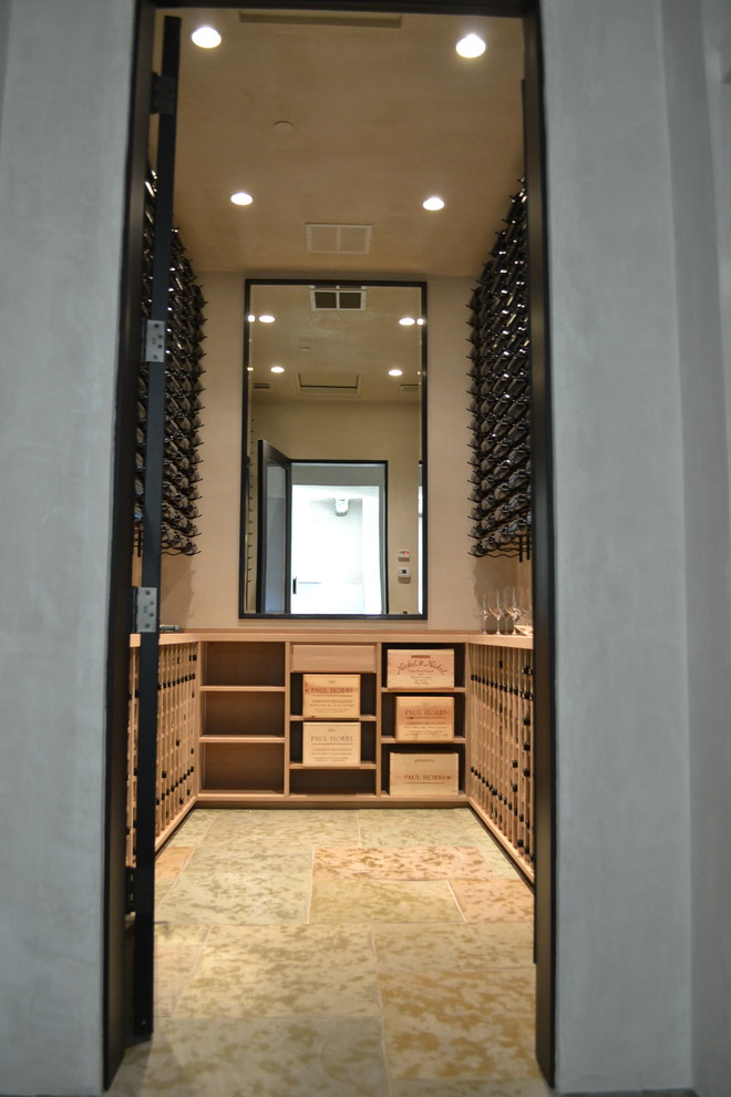 Large modern wine cellar in San Francisco with travertine floors and storage racks.