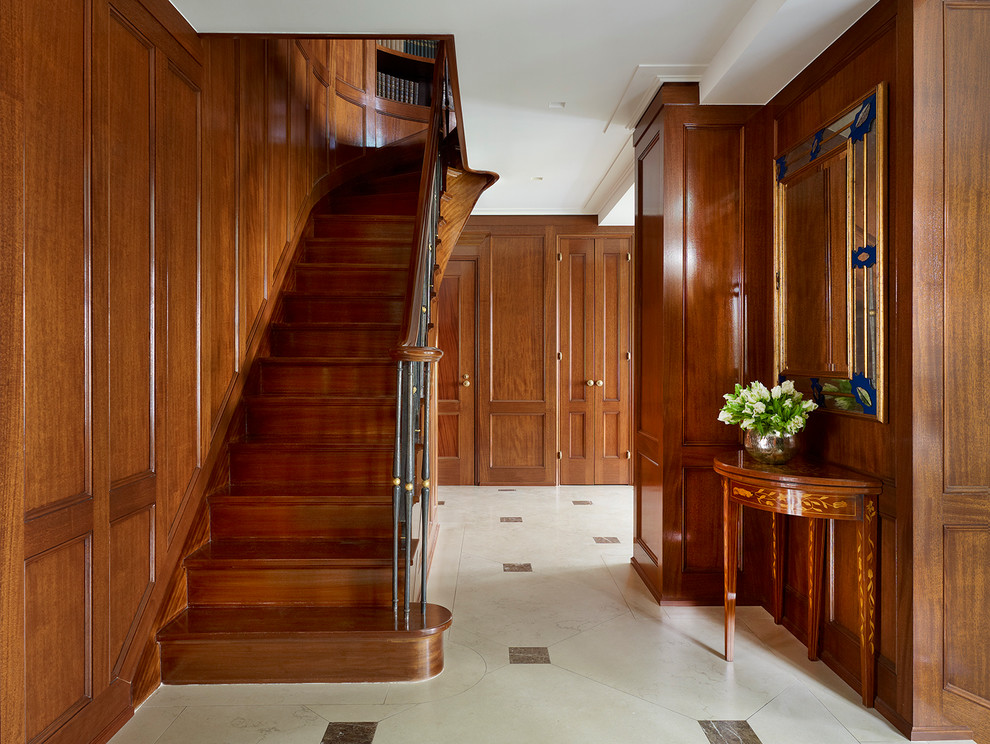 Inspiration for a large traditional foyer in New York with brown walls and marble floors.