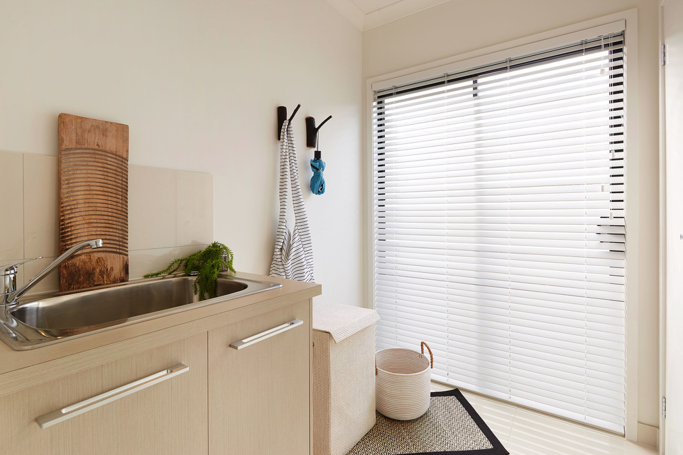 Photo of a beach style laundry room in Melbourne.