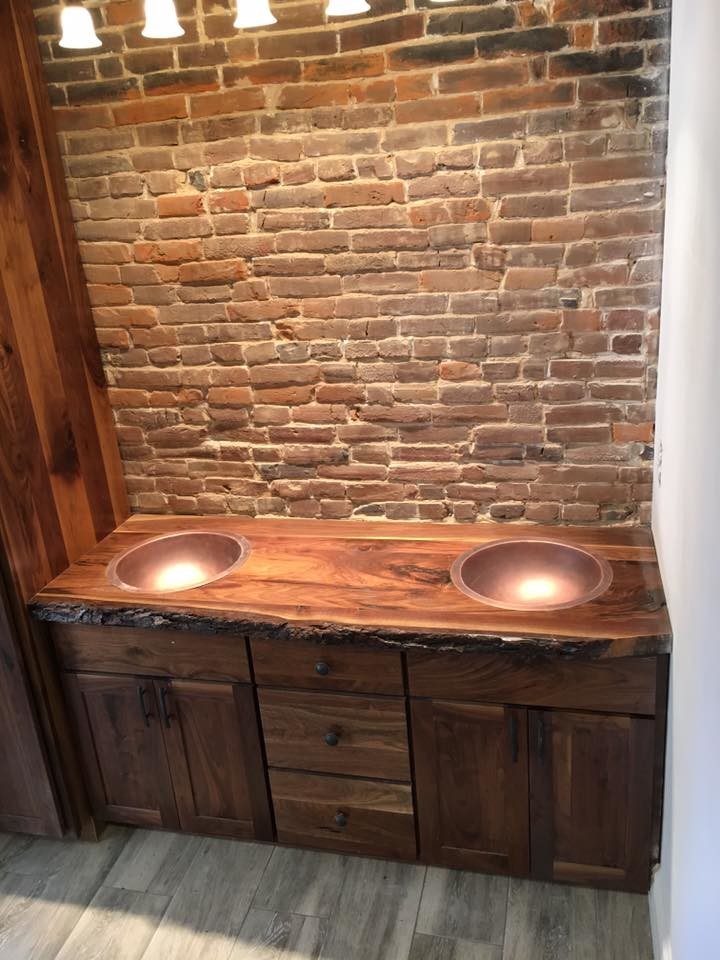 Inspiration for a mid-sized rustic master porcelain tile bathroom remodel with recessed-panel cabinets, medium tone wood cabinets, white walls, a drop-in sink and wood countertops