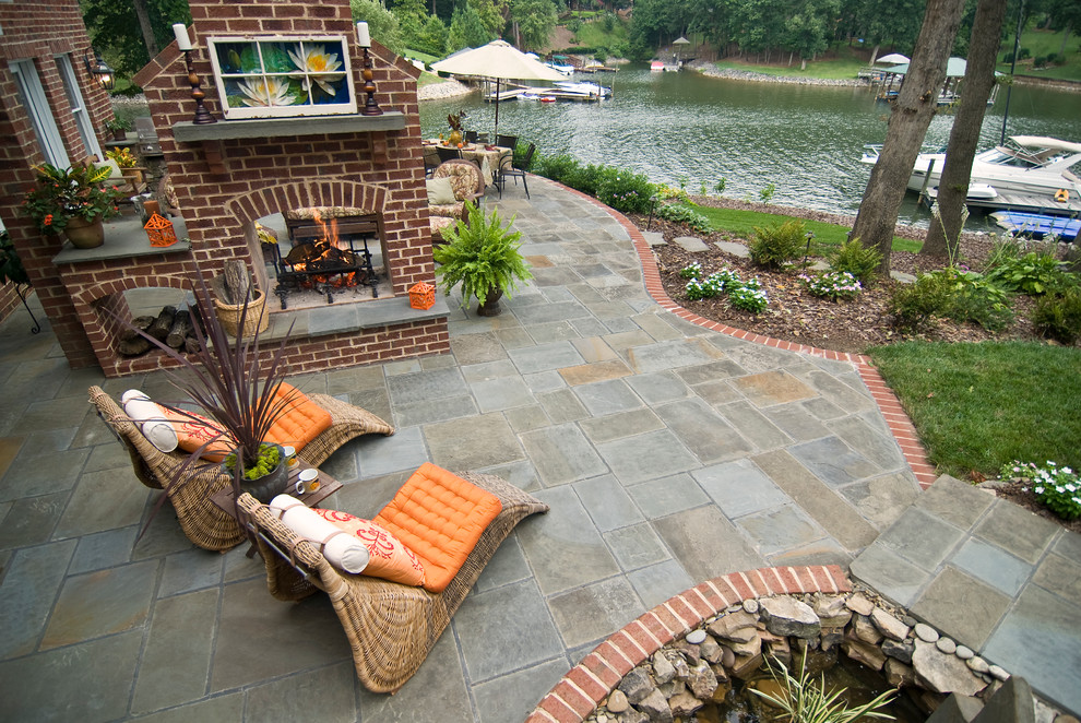 Transitional patio in Charlotte with a fire feature.