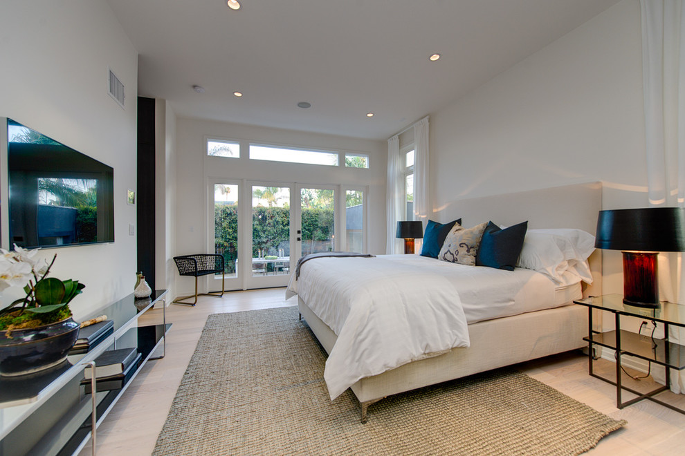 This is an example of a mid-sized contemporary bedroom in Los Angeles with white walls, linoleum floors and no fireplace.
