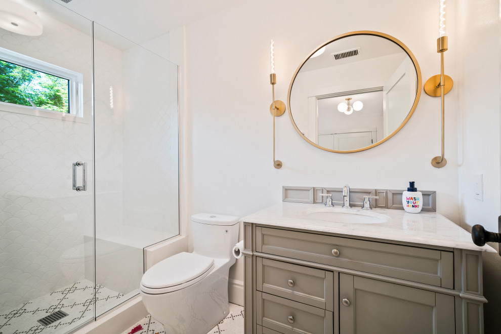 This is an example of a country bathroom in Los Angeles with recessed-panel cabinets, grey cabinets, an alcove shower, white tile, white walls, mosaic tile floors, an undermount sink, multi-coloured floor, a hinged shower door and white benchtops.