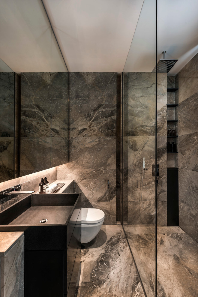 Photo of a contemporary bathroom in Singapore with flat-panel cabinets, black cabinets, a curbless shower, gray tile, an integrated sink and an open shower.