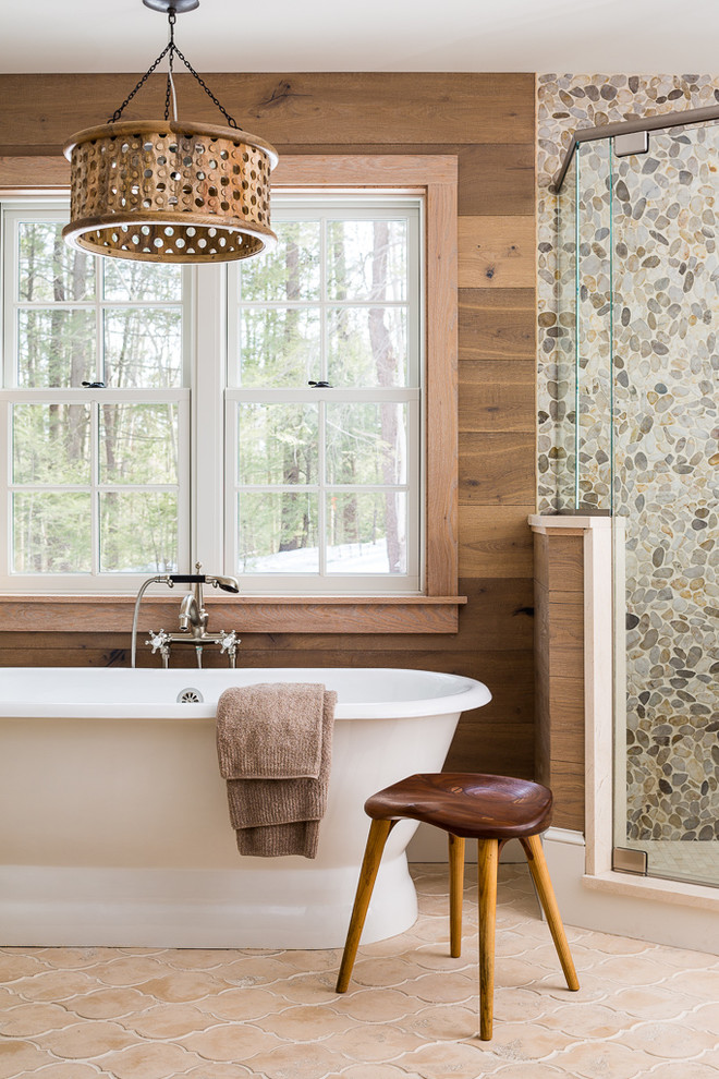 Inspiration for a beach style master bathroom in Portland Maine with a freestanding tub, a corner shower, multi-coloured tile and pebble tile.