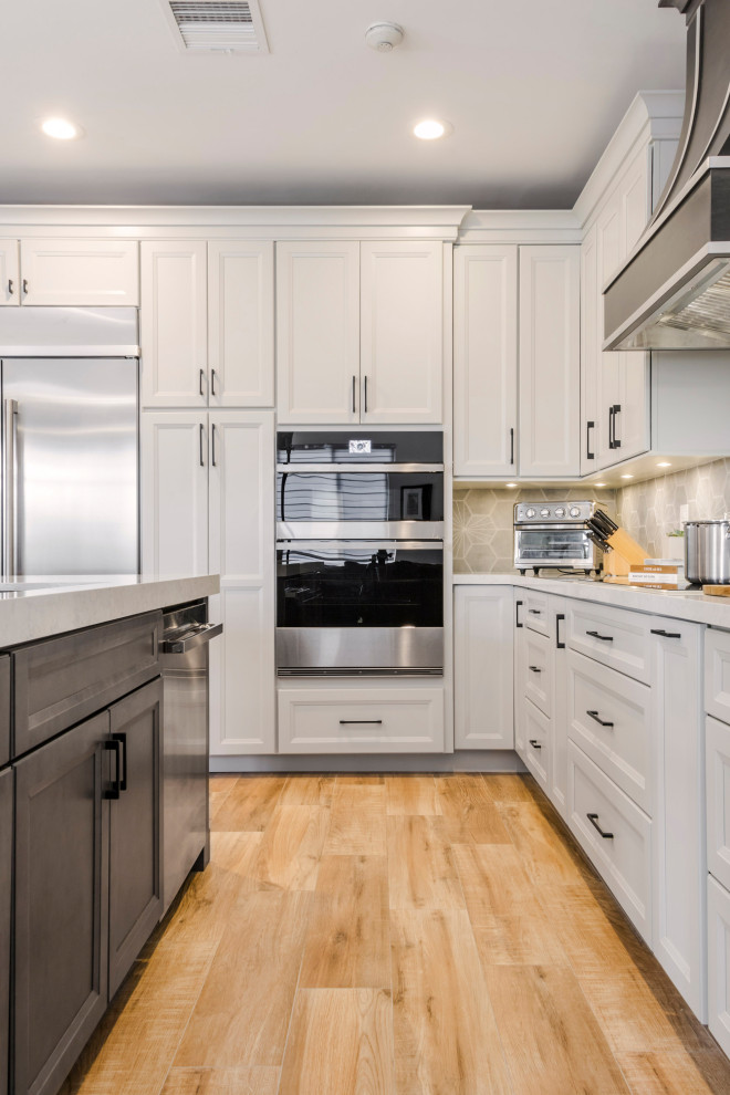 Kitchen - large transitional u-shaped porcelain tile and brown floor kitchen idea in Miami with an undermount sink, flat-panel cabinets, white cabinets, quartz countertops, gray backsplash, porcelain backsplash and white countertops