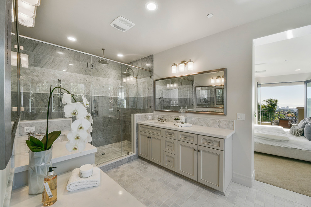 Large mediterranean master bathroom in San Francisco with recessed-panel cabinets, grey cabinets, a freestanding tub, a double shower, a one-piece toilet, gray tile, ceramic tile, grey walls, ceramic floors, an undermount sink and quartzite benchtops.