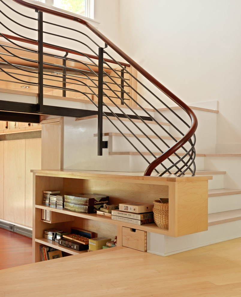 This is an example of a contemporary wood staircase in Burlington with painted wood risers.