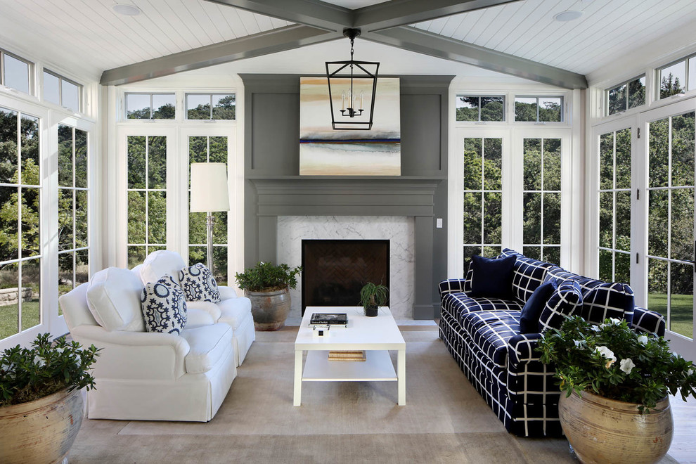 Inspiration for a mid-sized country sunroom in San Francisco with a standard fireplace, a standard ceiling, a stone fireplace surround and grey floor.