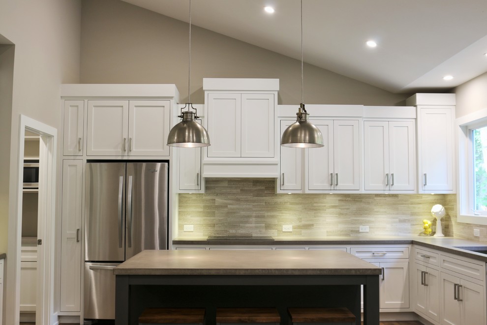 Example of a large transitional l-shaped dark wood floor open concept kitchen design in Grand Rapids with an undermount sink, shaker cabinets, white cabinets, quartz countertops, beige backsplash, porcelain backsplash, stainless steel appliances and an island