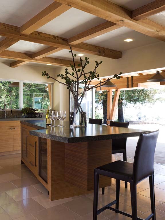 Inspiration for an expansive contemporary eat-in kitchen in San Francisco with an undermount sink, flat-panel cabinets, light wood cabinets, granite benchtops, multi-coloured splashback, stainless steel appliances, limestone floors and multiple islands.