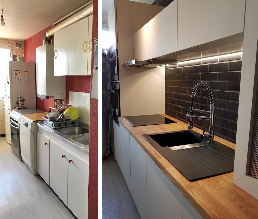 Design ideas for a small contemporary single-wall separate kitchen in Reims with a single-bowl sink, white cabinets, wood benchtops, black splashback, brick splashback, stainless steel appliances, vinyl floors, no island, grey floor and brown benchtop.