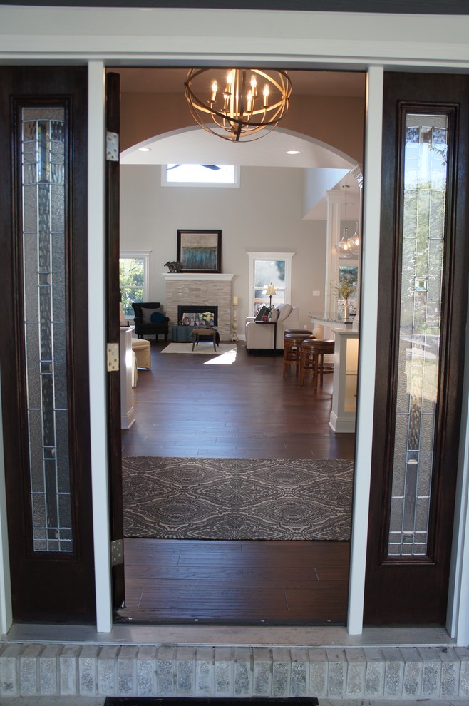Example of a transitional dark wood floor entryway design