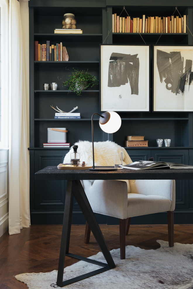 Photo of a transitional home office in San Francisco with medium hardwood floors, a freestanding desk and black walls.