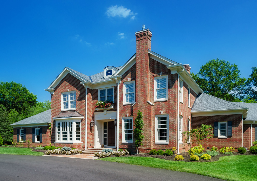 Large traditional two-storey brick brown exterior in Cincinnati with a gable roof.