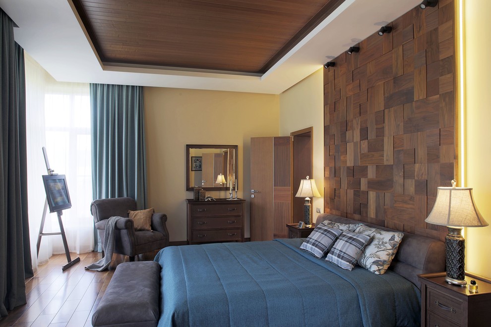 Inspiration for a large traditional master bedroom in Moscow with beige walls, dark hardwood floors and brown floor.