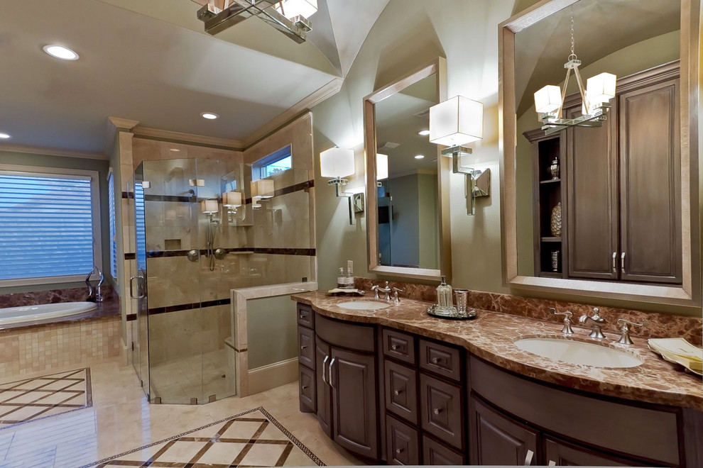 Design ideas for a large transitional master bathroom in Houston with an undermount sink, furniture-like cabinets, marble benchtops, a drop-in tub, a corner shower, a two-piece toilet, beige tile, green walls, marble floors and dark wood cabinets.