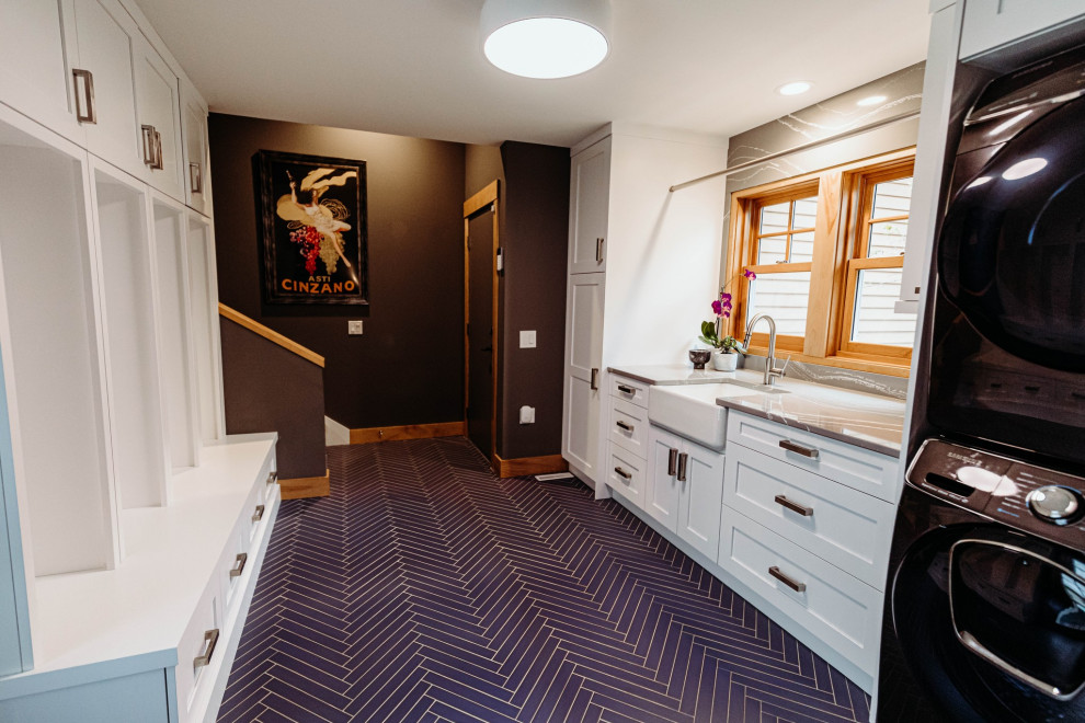 Design ideas for a large traditional galley utility room in Other with a belfast sink, shaker cabinets, white cabinets, engineered stone countertops, grey splashback, engineered quartz splashback, grey walls, porcelain flooring, a stacked washer and dryer, blue floors and grey worktops.