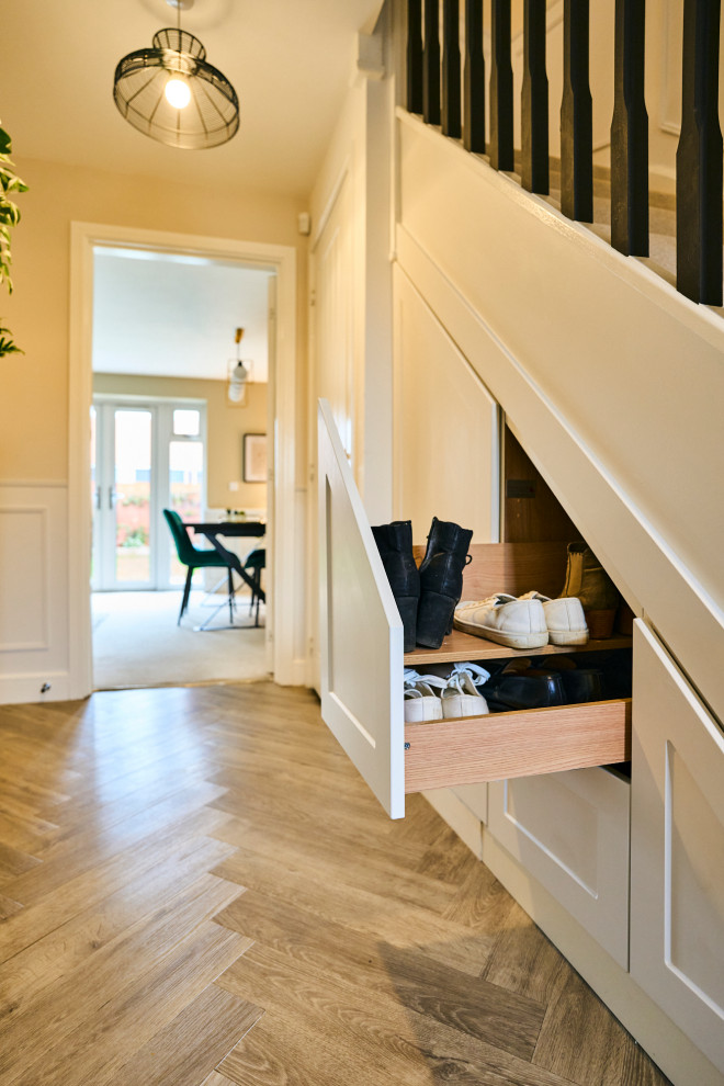 Inspiration for a small transitional hallway in Hampshire with beige walls, light hardwood floors, beige floor and decorative wall panelling.