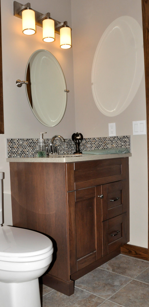 Small arts and crafts powder room in Calgary with shaker cabinets, dark wood cabinets, a two-piece toilet, multi-coloured tile, mosaic tile, grey walls, an undermount sink and granite benchtops.