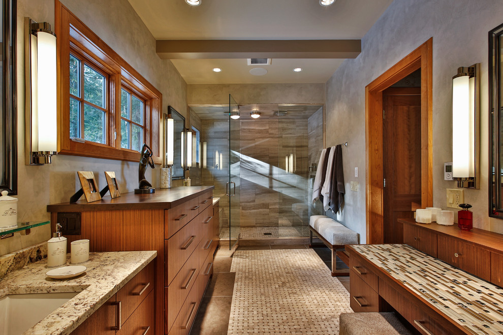 This is an example of a large country master bathroom in Boston with an undermount sink, flat-panel cabinets, medium wood cabinets, an alcove shower, mosaic tile floors, marble benchtops, beige tile and gray tile.