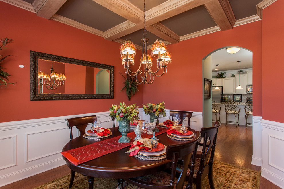 Photo of a traditional separate dining room in Other with dark hardwood floors and pink walls.