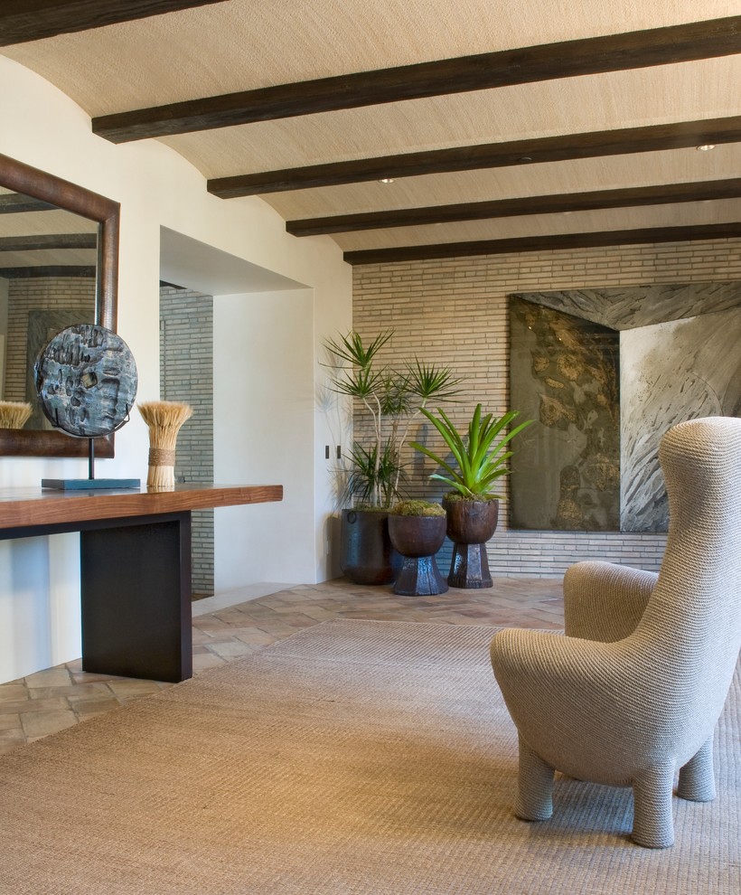 This is an example of a mid-sized contemporary foyer in Santa Barbara with white walls and slate floors.