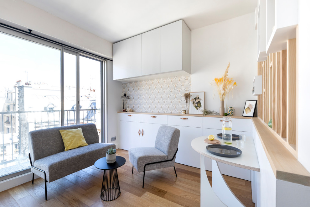 Design ideas for a small open concept living room in Paris with white walls and plywood floors.