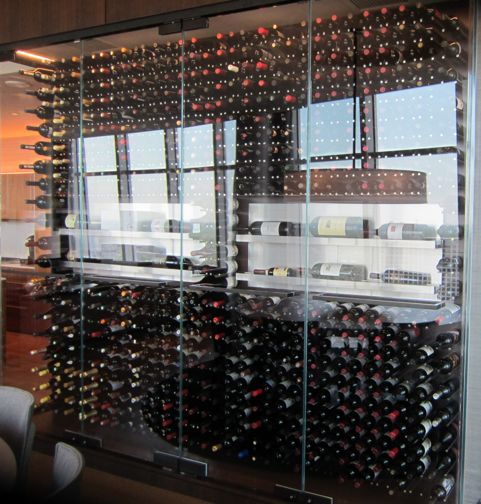 Small modern wine cellar in Dallas with storage racks and brown floor.