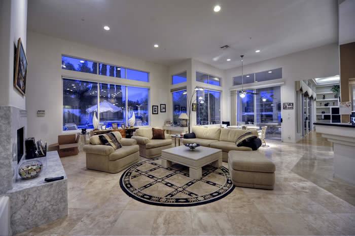 Expansive contemporary formal open concept living room in Phoenix with beige walls, porcelain floors, a standard fireplace and a stone fireplace surround.