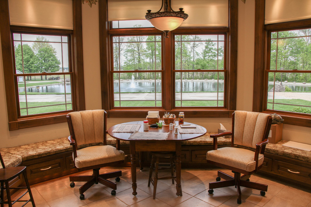 Eat-in kitchen - huge rustic u-shaped ceramic tile and beige floor eat-in kitchen idea with a double-bowl sink, raised-panel cabinets, dark wood cabinets, marble countertops, beige backsplash, ceramic backsplash, white appliances and an island