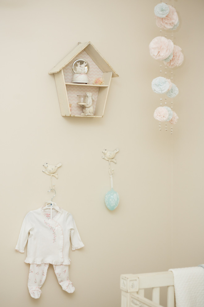 Mid-sized transitional girl dark wood floor nursery photo with beige walls