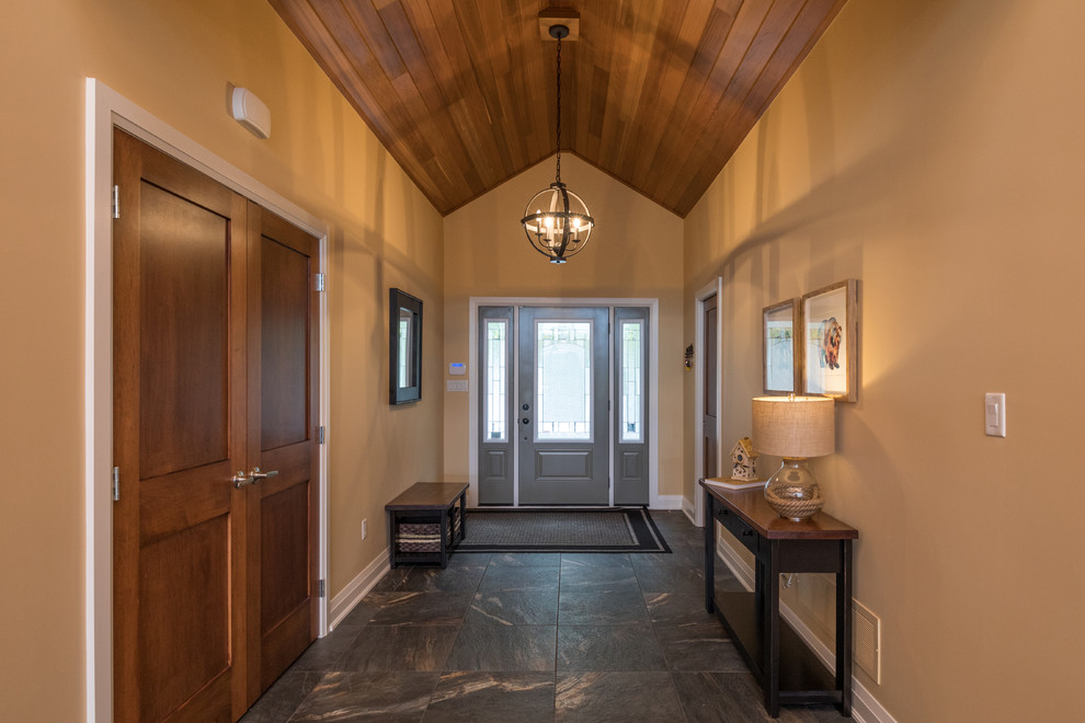 Mid-sized transitional gray floor entry hall photo in Toronto with gray walls and a gray front door