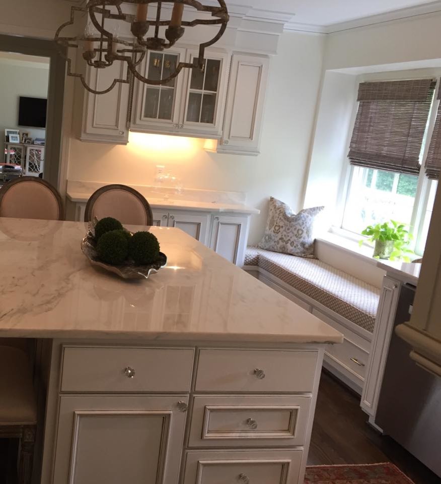 Inspiration for a mid-sized transitional l-shaped dark wood floor eat-in kitchen remodel with an undermount sink, recessed-panel cabinets, white cabinets, granite countertops, white backsplash, stainless steel appliances and an island